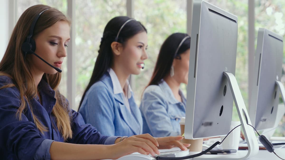 Professional office team using headsets and computers in a Dallas-Fort Worth business — the outcome of a properly installed and employee-trained cloud phone system from NTI Technologies