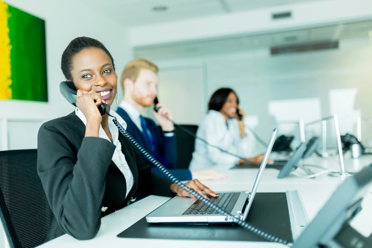 Business office team answering calls using an auto-attendant phone system in Dallas-Fort Worth