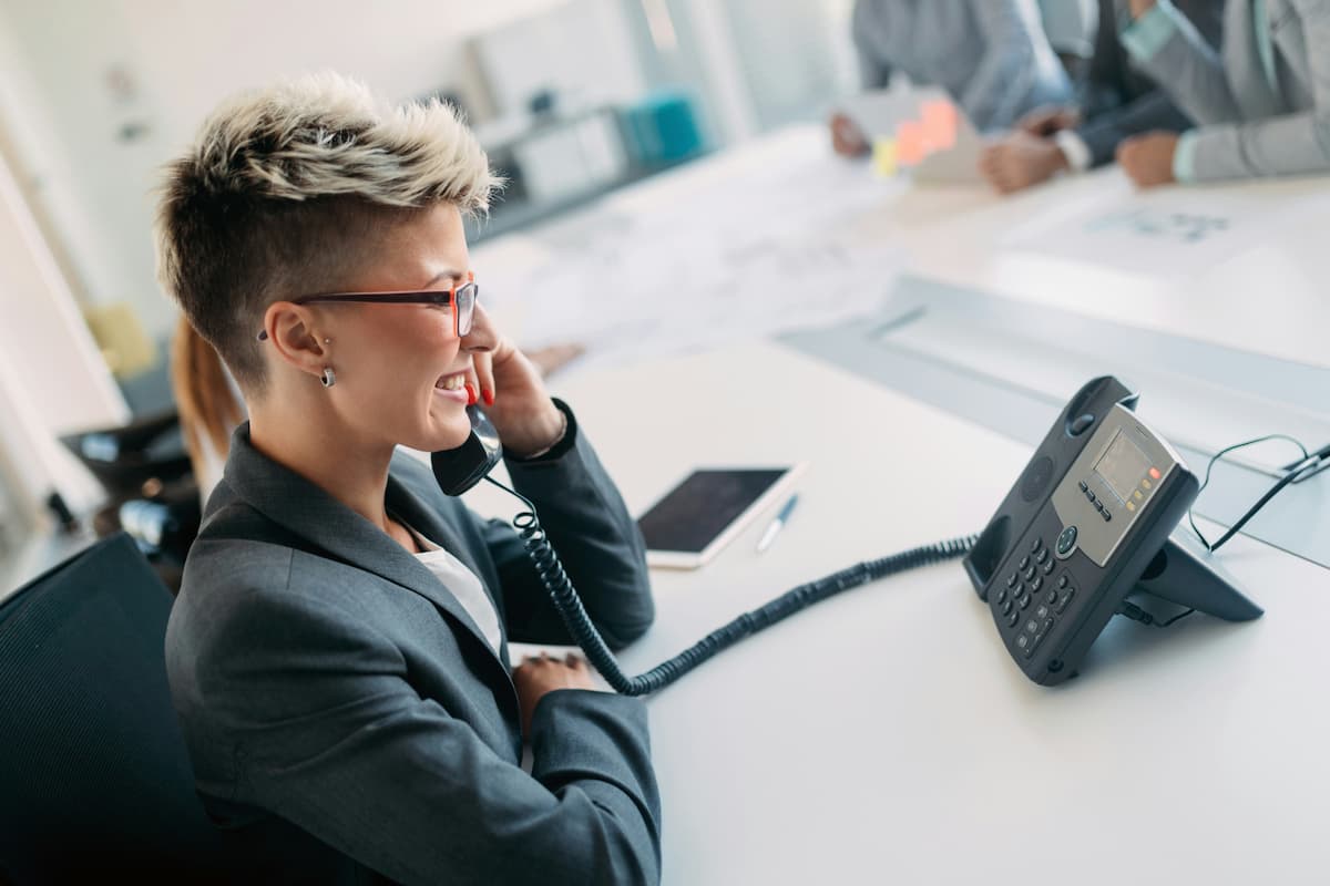 Business professional comparing Intermedia Elevate vs RingCentral cloud phone system in DFW office