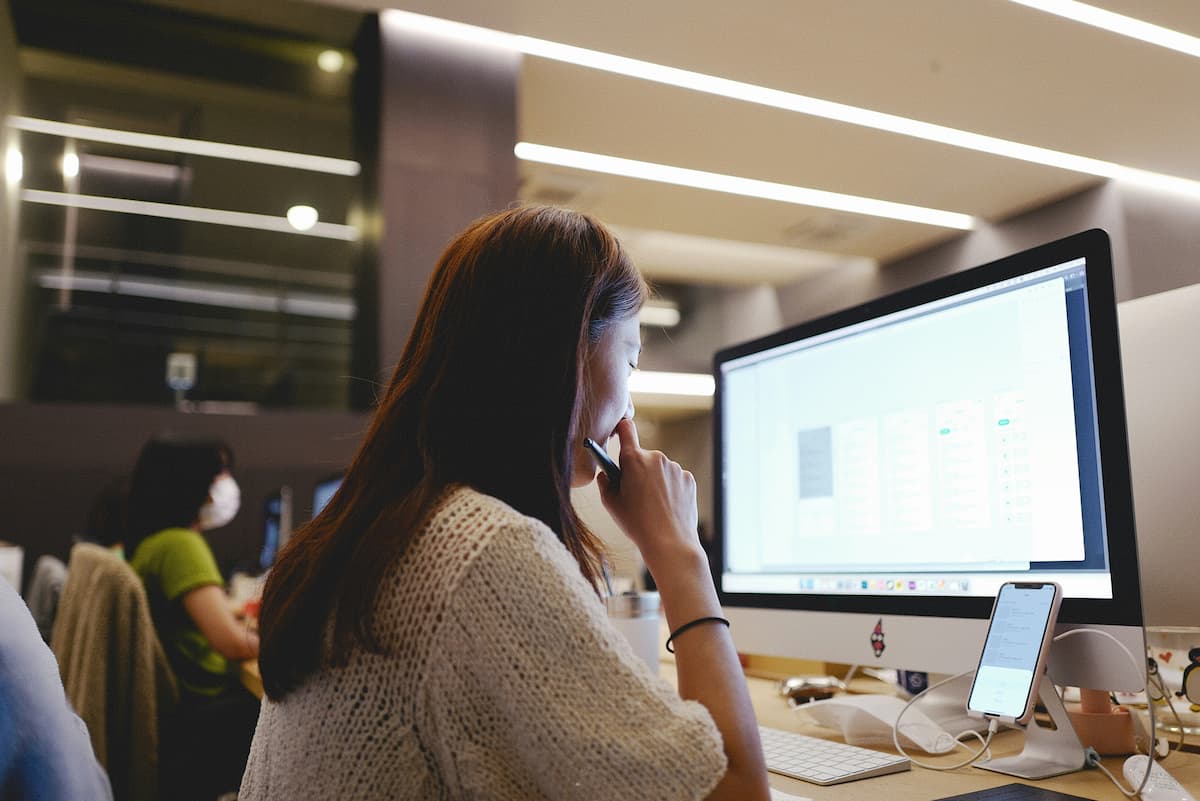 IT professional reviewing VoIP network requirements on computer before deploying cloud phone system