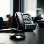 Outdated office desk phone showing signs an aging business phone system needs replacing