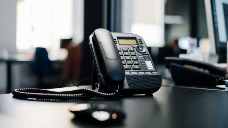 Outdated office desk phone showing signs an aging business phone system needs replacing