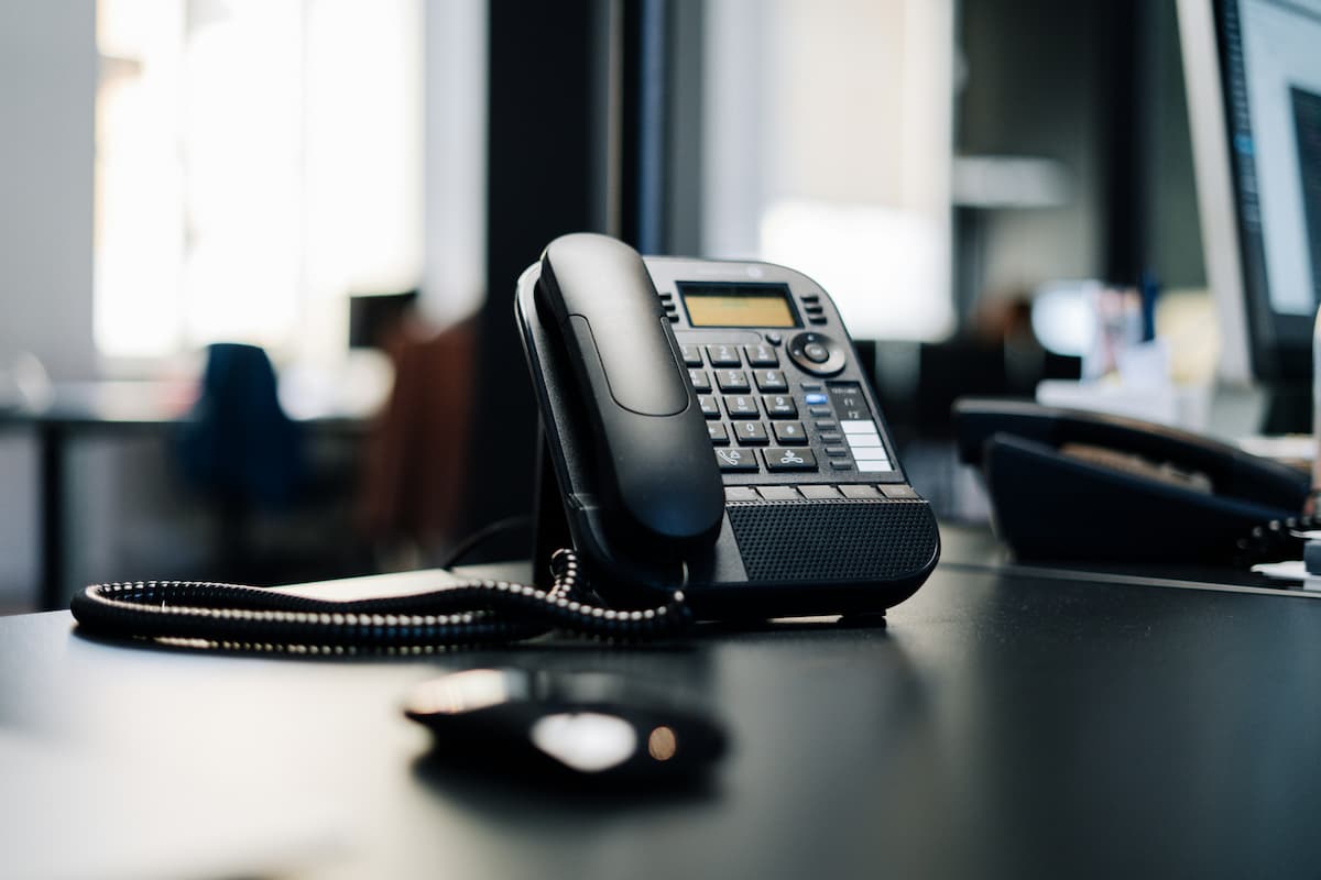 Outdated office desk phone showing signs an aging business phone system needs replacing