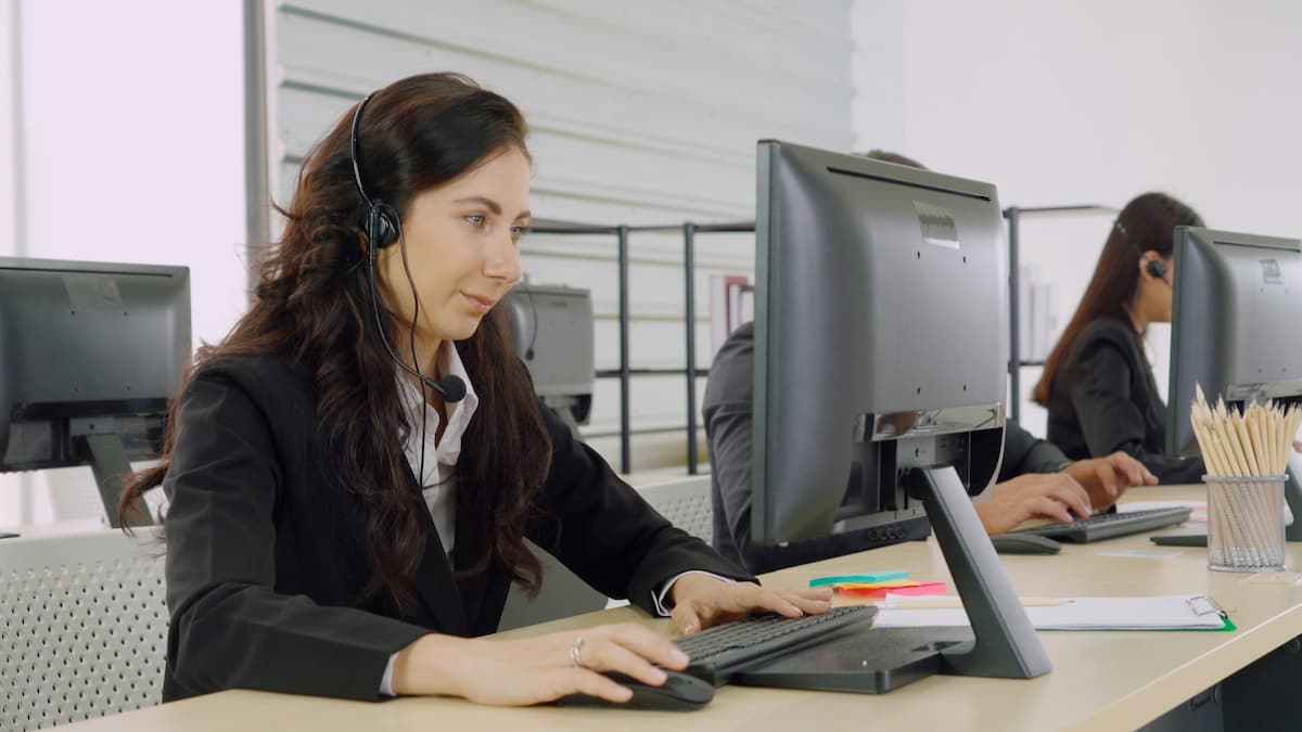 Legal office professional using a cloud law firm phone system with headset in a Dallas law office