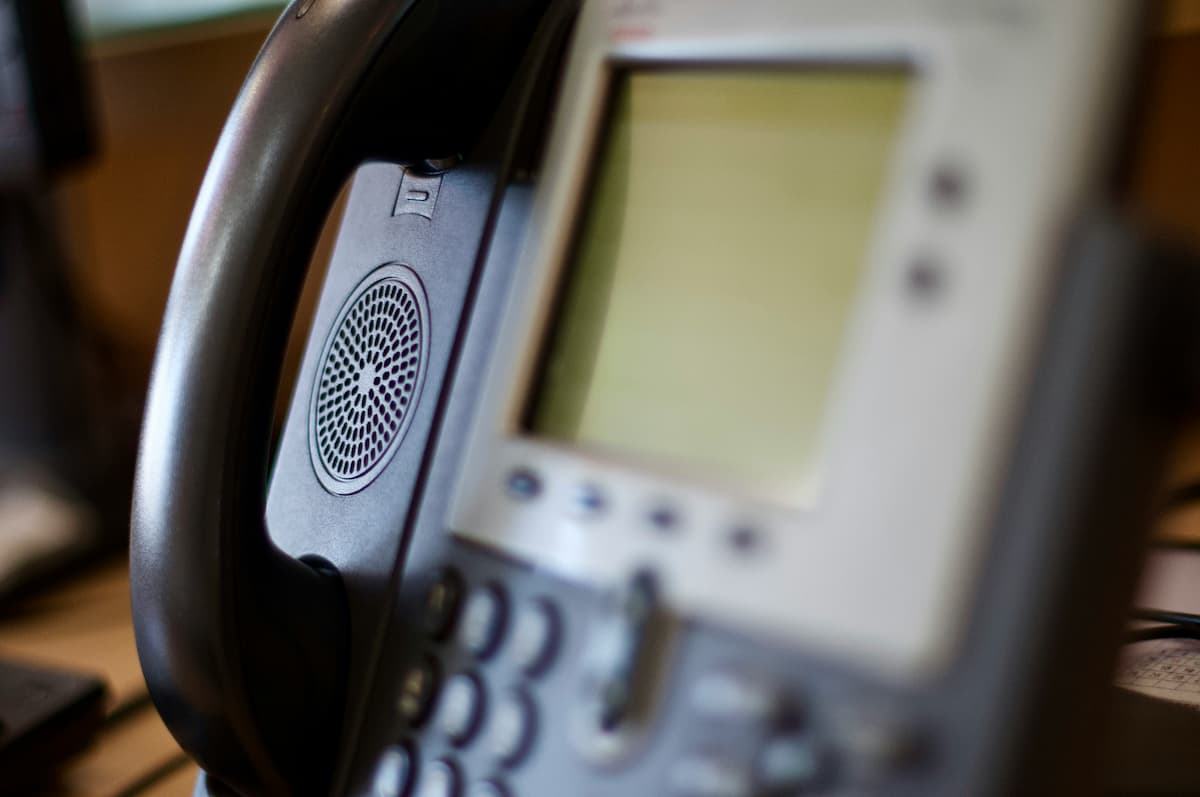 Traditional office phone handset representing the difference between VoIP and landline phone systems for DFW businesses