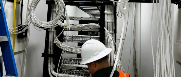 Dallas structured cabling technician organizing network cabling during law office infrastructure project