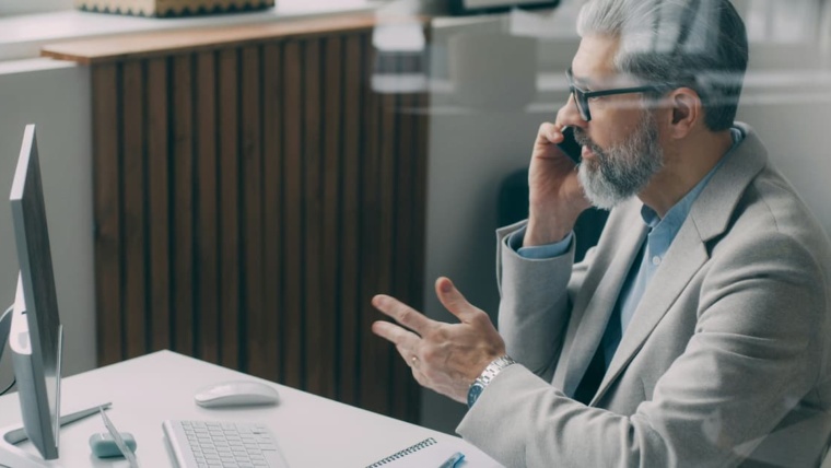 Dental practice owner using cloud phone system for patient communication in Dallas-Fort Worth office
