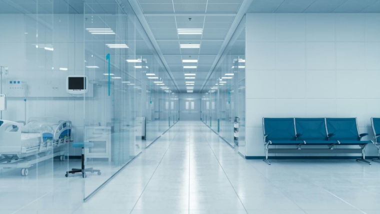 Medical office access control Dallas — clinical healthcare hallway with glass-walled patient areas representing the HIPAA-compliant controlled access zones NTi Technologies configures for DFW medical facilities