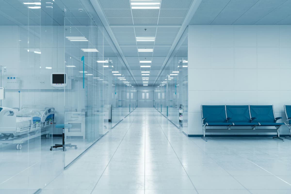 Medical office access control Dallas — clinical healthcare hallway with glass-walled patient areas representing the HIPAA-compliant controlled access zones NTi Technologies configures for DFW medical facilities