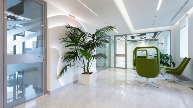 Multi-tenant access control Dallas — modern commercial office building lobby with glass-paneled controlled doors representing the tiered access control architecture NTi Technologies installs for DFW multi-tenant buildings