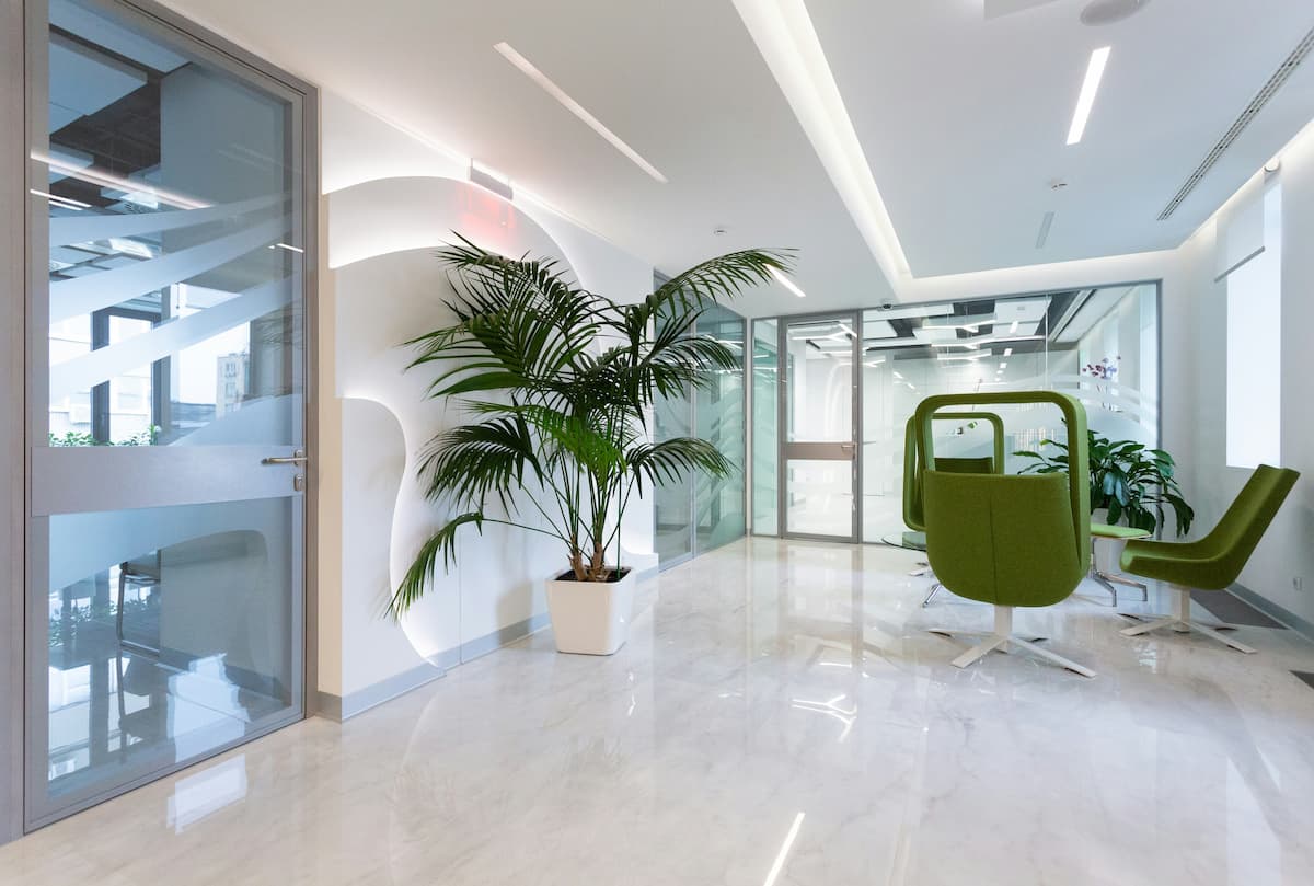Multi-tenant access control Dallas — modern commercial office building lobby with glass-paneled controlled doors representing the tiered access control architecture NTi Technologies installs for DFW multi-tenant buildings