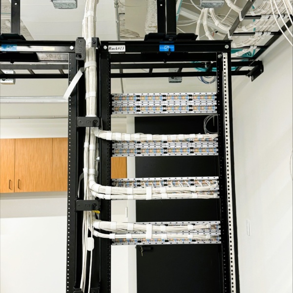 Structured cabling rack with organized patch panels and cable pathways.