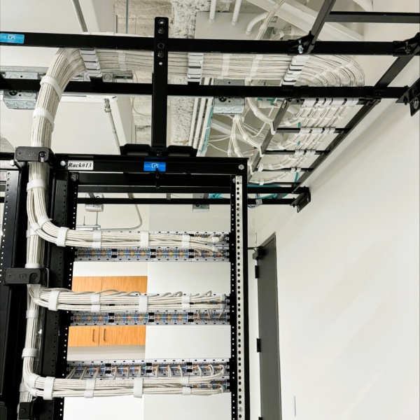 Structured cabling rack with neatly routed cables and patch panels.
