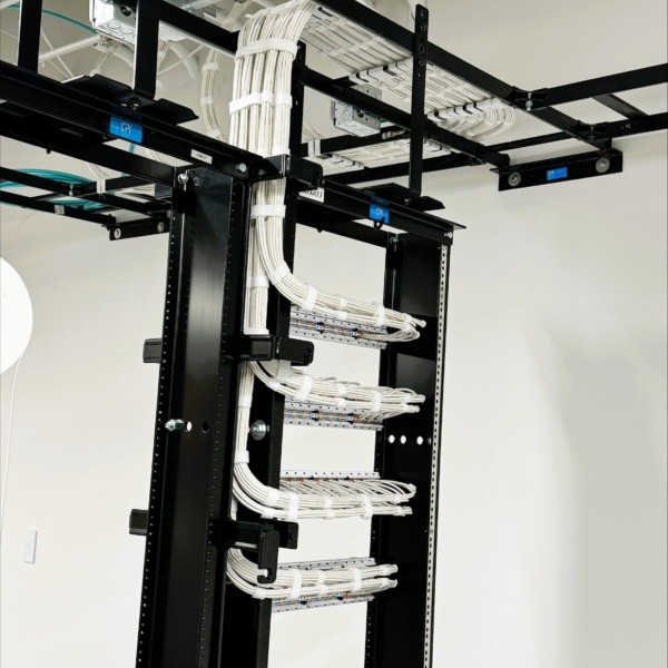 Side view of network rack with neatly bundled structured cabling.