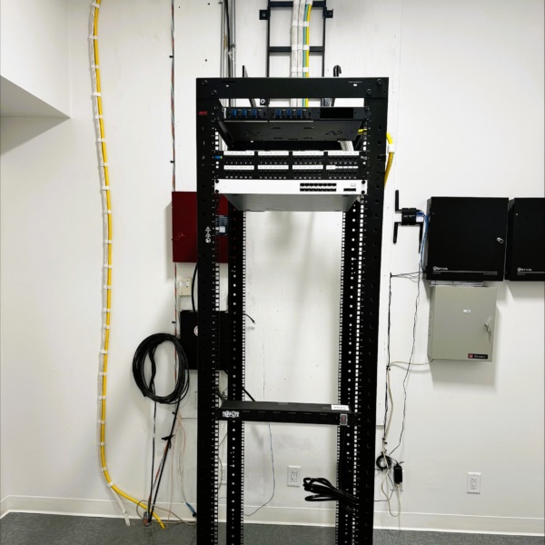 Equipment rack area with access control panels mounted on the wall.