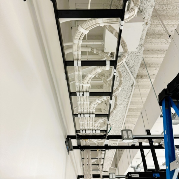 Overhead cable tray with neatly managed structured cabling.