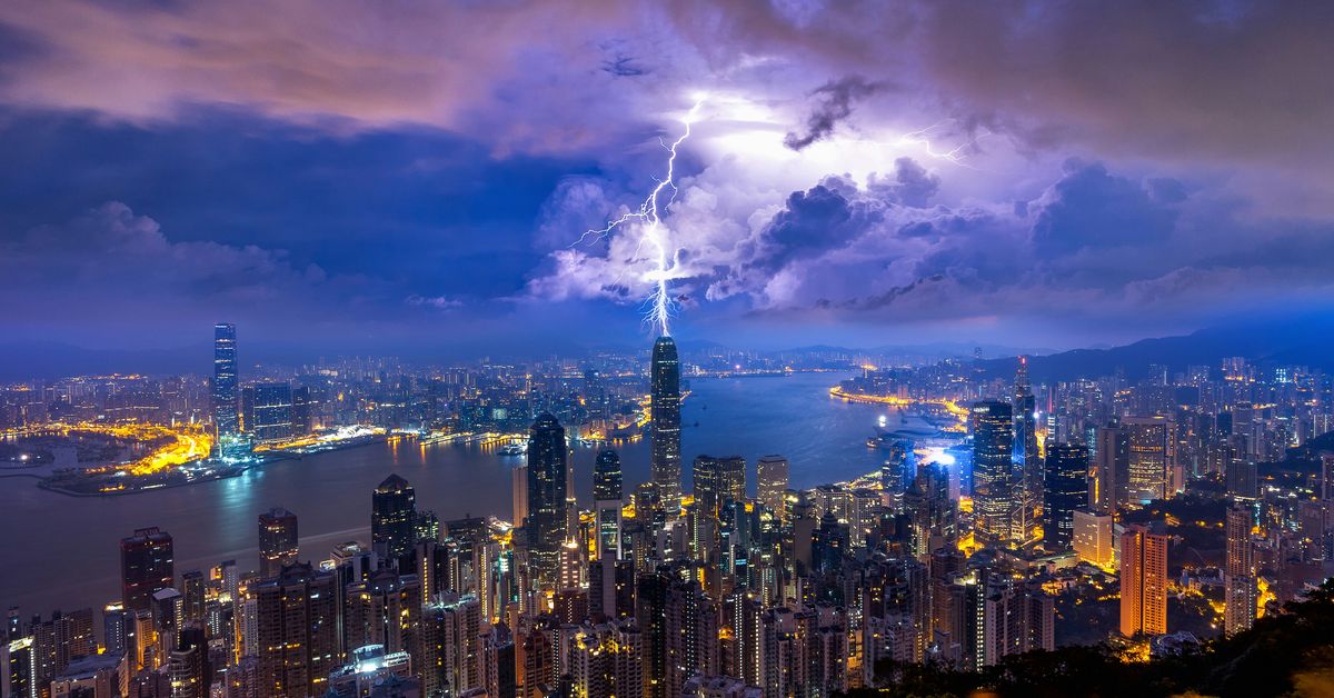 Phone system storm outage risk shown through severe weather over a city skyline